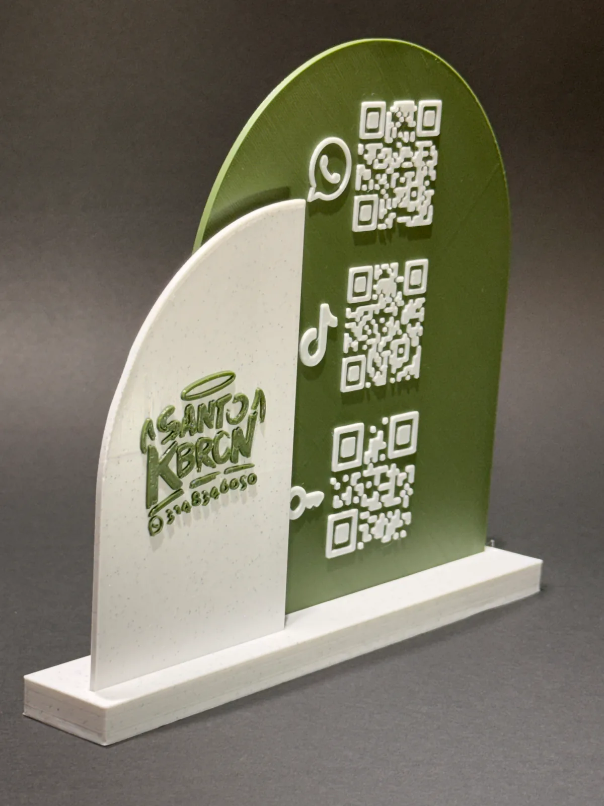 Placa QR con base verde y blanca en tres cuartos desde la izquierda, apoyada en su base blanca de encaje sobre fondo gris de estudio — Solid Lab 3D, Colombia